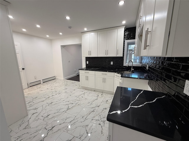 kitchen featuring decorative backsplash, sink, white cabinets, and a baseboard heating unit