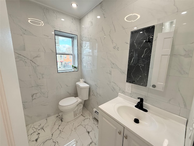 bathroom with vanity, a baseboard radiator, toilet, and tile walls