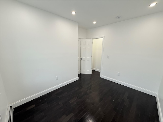 spare room featuring dark hardwood / wood-style floors