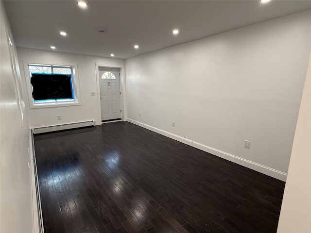 foyer entrance with dark hardwood / wood-style flooring and a baseboard radiator