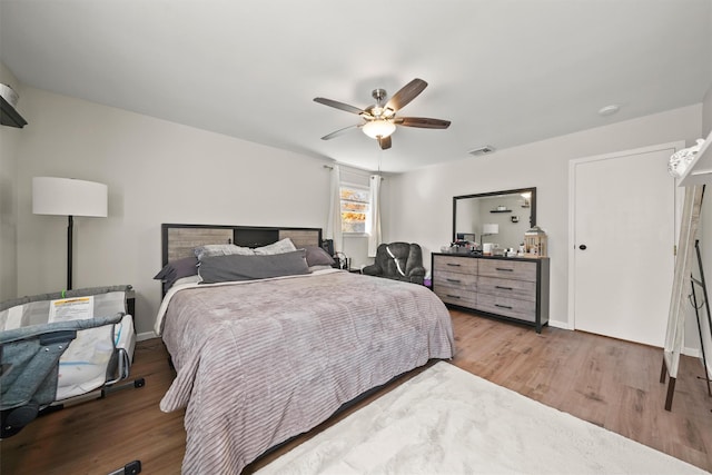 bedroom featuring hardwood / wood-style flooring and ceiling fan