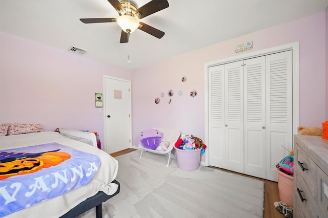 bedroom with ceiling fan and a closet