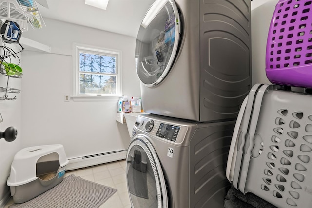 laundry area featuring baseboard heating and stacked washer and clothes dryer