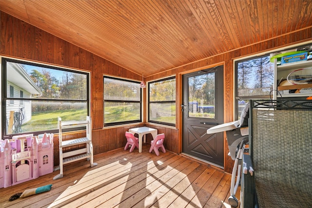 sunroom / solarium featuring lofted ceiling and wood ceiling