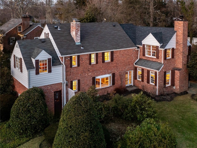 rear view of house featuring a yard