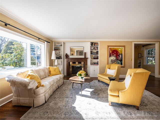 living room featuring dark wood-type flooring and ornamental molding