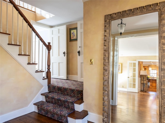 stairs with hardwood / wood-style floors