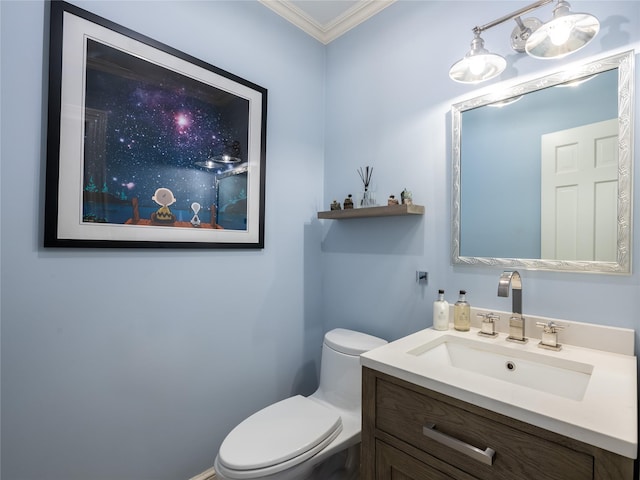 bathroom with toilet, vanity, and crown molding