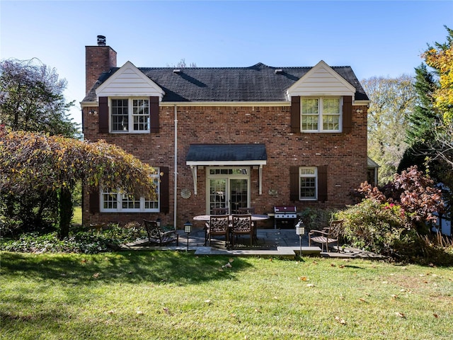 back of property featuring a patio area and a yard