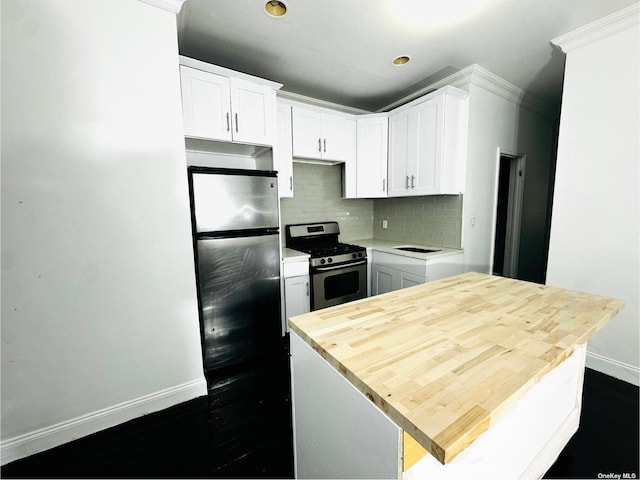 kitchen with decorative backsplash, white cabinetry, and appliances with stainless steel finishes