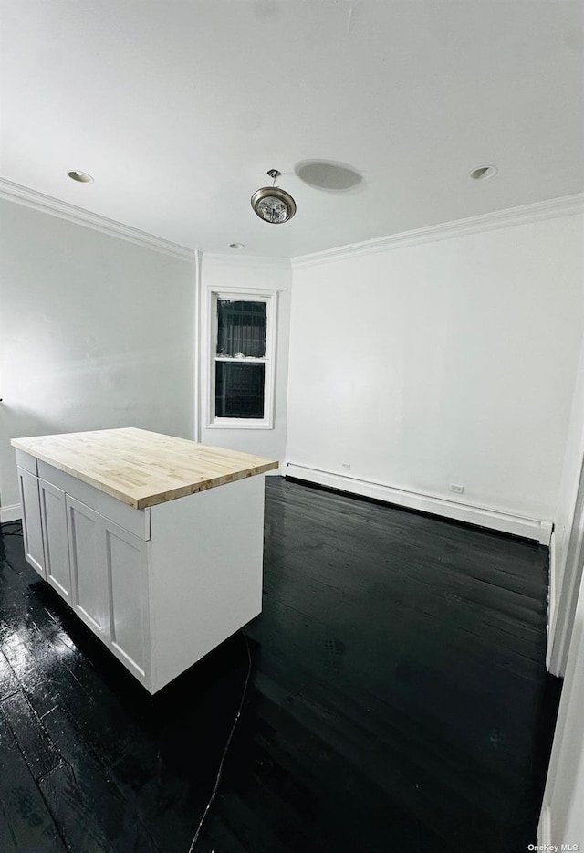 kitchen with a center island, ornamental molding, a baseboard radiator, dark hardwood / wood-style flooring, and white cabinetry