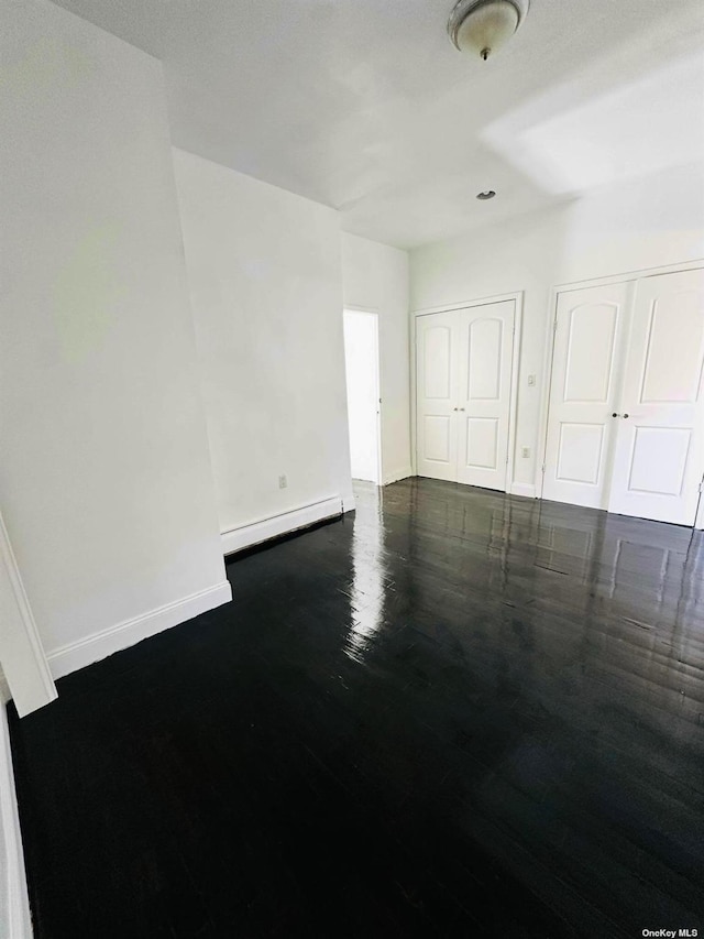 empty room featuring a baseboard heating unit