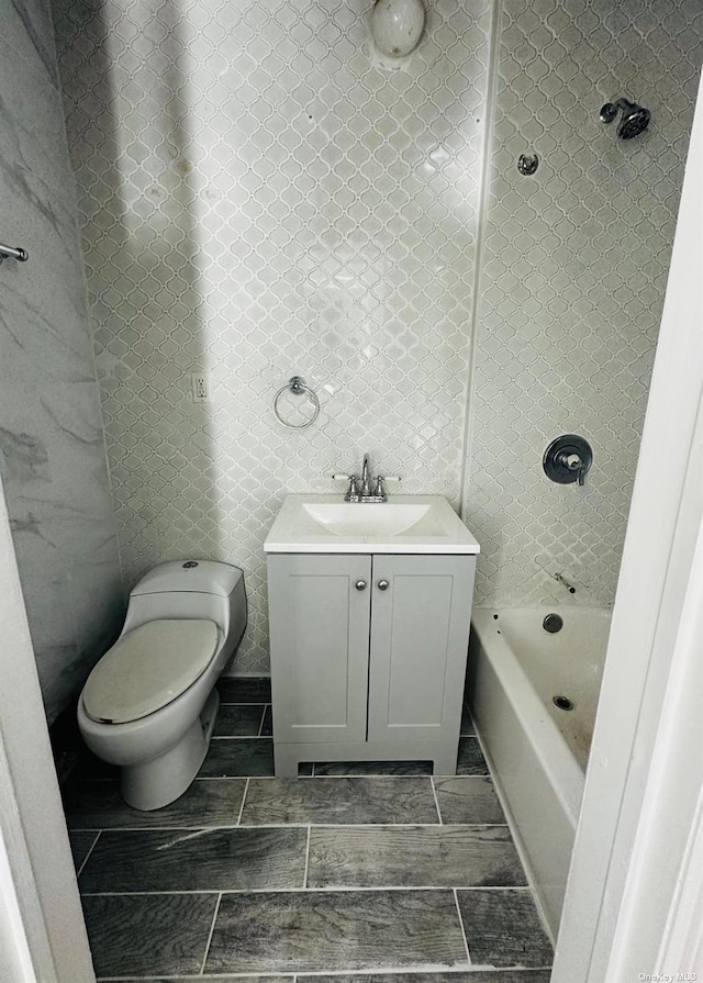 full bathroom featuring vanity, toilet, and tiled shower / bath combo