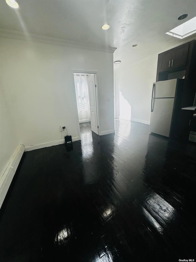 interior space with ornamental molding and a skylight