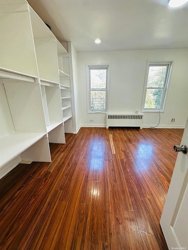 interior space featuring radiator heating unit and dark hardwood / wood-style floors