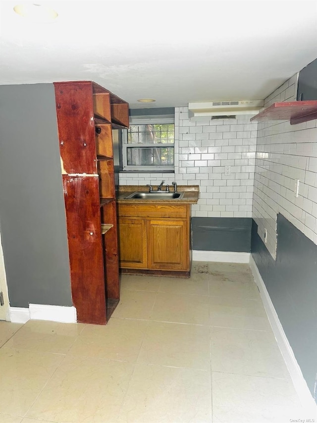 kitchen featuring ventilation hood and sink