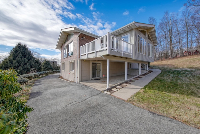 view of property exterior featuring a yard and a wooden deck