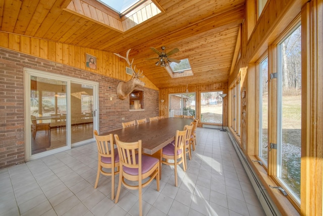 sunroom / solarium with ceiling fan, vaulted ceiling with skylight, and wood ceiling