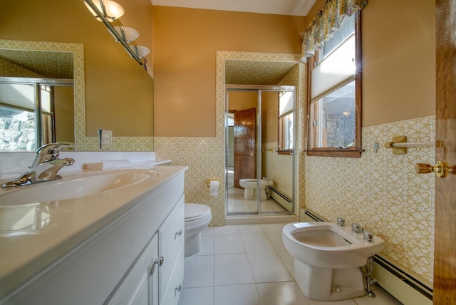 bathroom with tile walls, a bidet, a baseboard radiator, and toilet