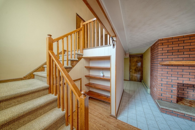 staircase with hardwood / wood-style floors