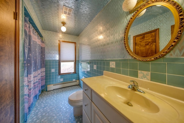 bathroom with tile walls, toilet, walk in shower, a baseboard heating unit, and vanity