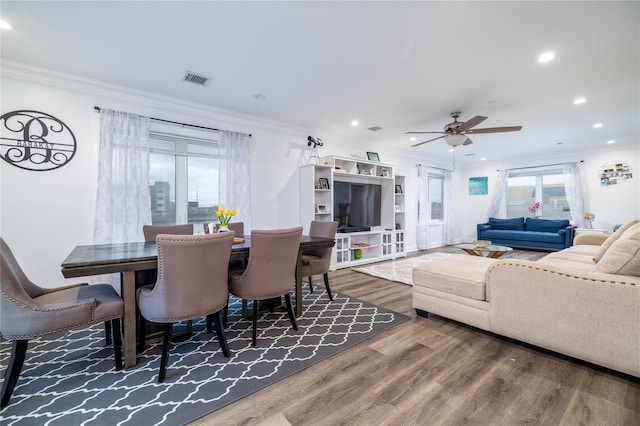 dining space with ornamental molding, ceiling fan, and hardwood / wood-style floors