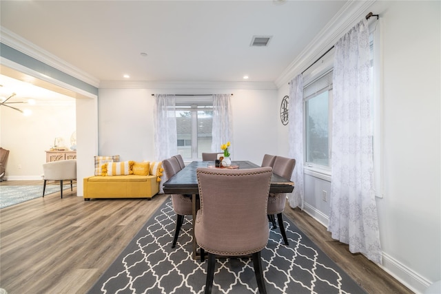 dining area with dark hardwood / wood-style flooring and ornamental molding