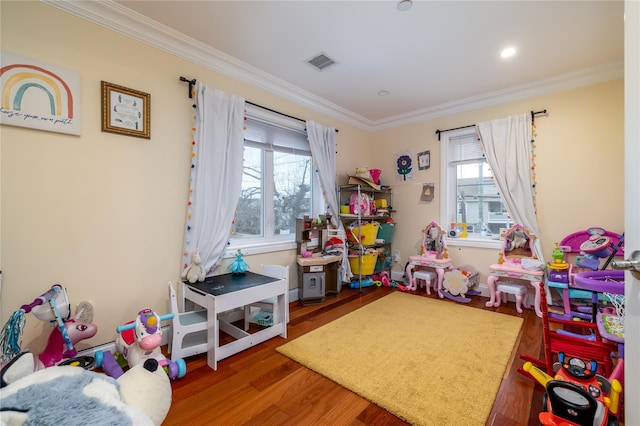 playroom with wood-type flooring and ornamental molding