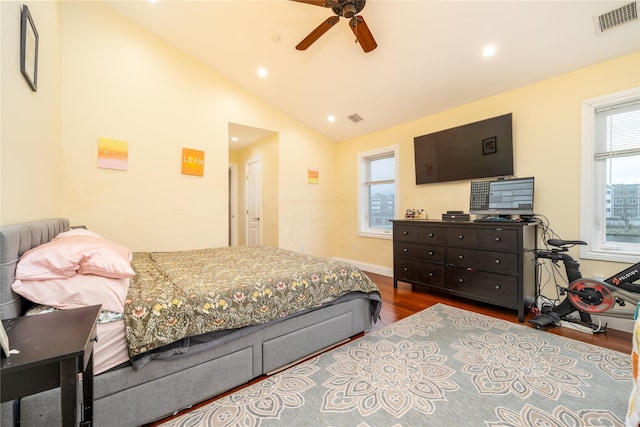 bedroom featuring ceiling fan, vaulted ceiling, and wood-type flooring