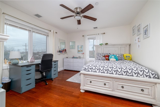 bedroom with ceiling fan and dark wood-type flooring