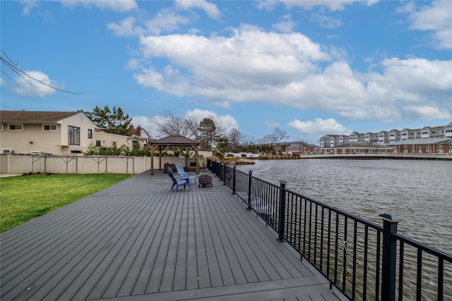 deck with a gazebo, a lawn, and a water view