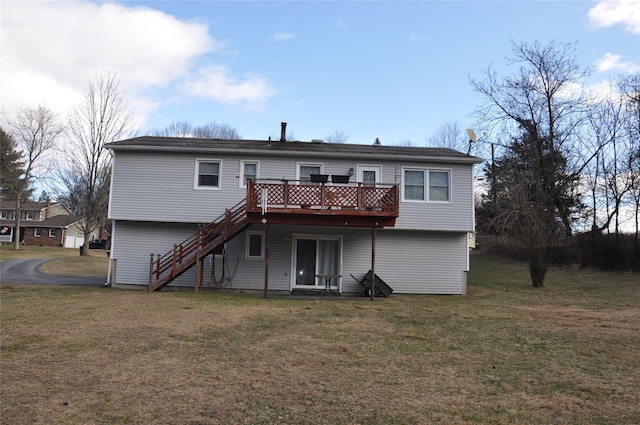 rear view of house with a deck and a yard