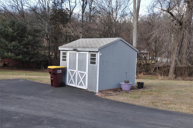 view of outbuilding featuring a lawn