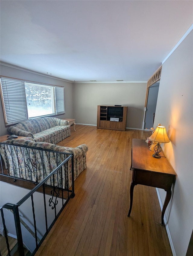 living room featuring hardwood / wood-style flooring and ornamental molding