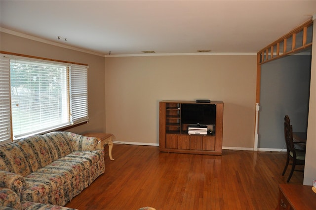 living room with crown molding and hardwood / wood-style flooring