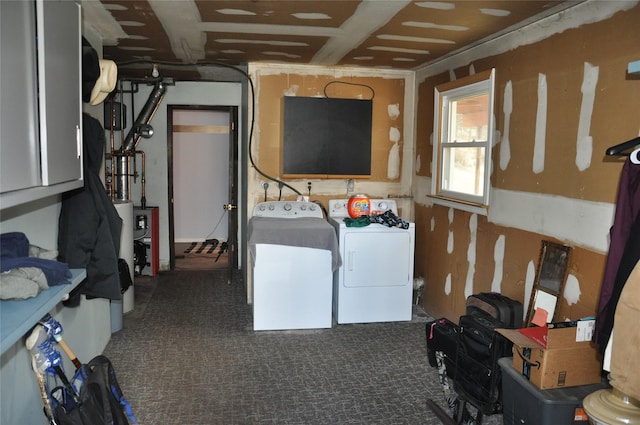 washroom with dark carpet and washing machine and clothes dryer