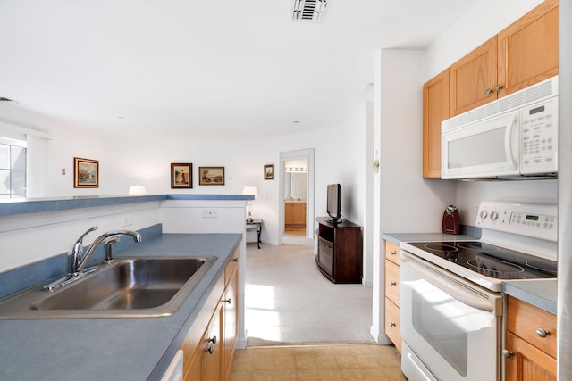 kitchen featuring white appliances and sink