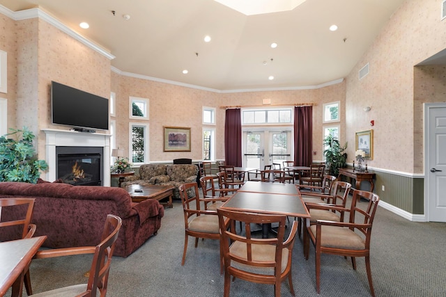 dining space with ornamental molding, french doors, and carpet