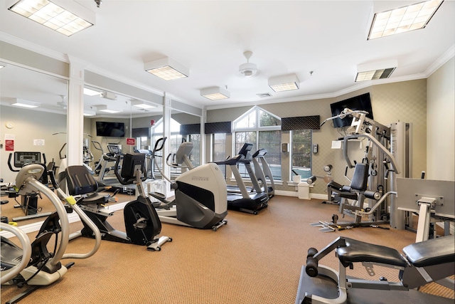 gym with ceiling fan and crown molding