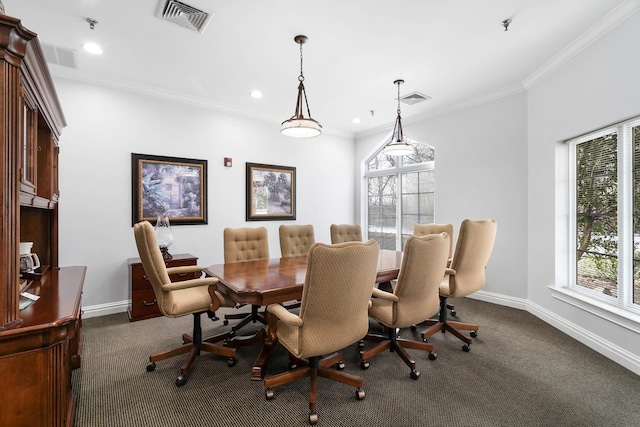 carpeted dining area featuring crown molding