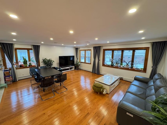 living room with a baseboard radiator and light hardwood / wood-style floors