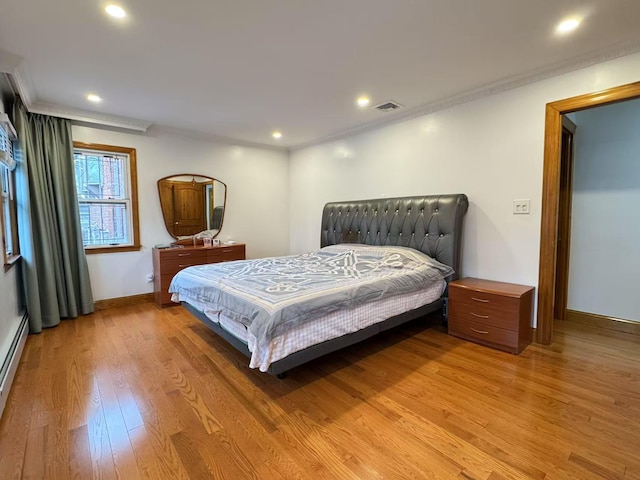 bedroom featuring wood-type flooring and ornamental molding