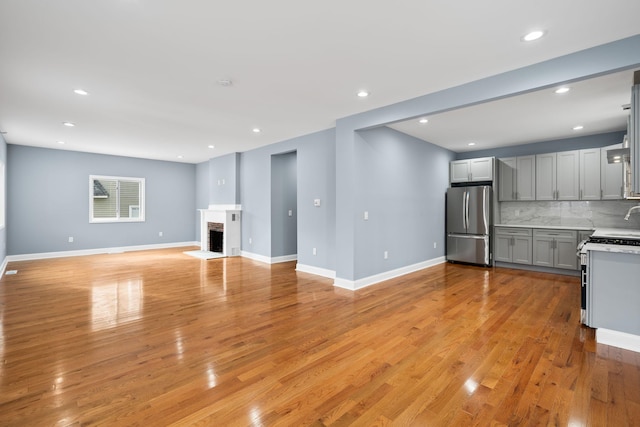 unfurnished living room with a fireplace and light hardwood / wood-style flooring