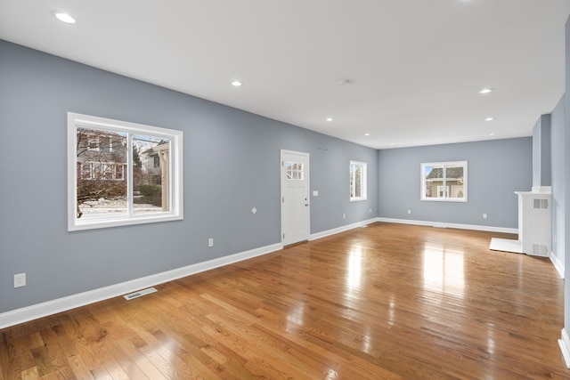 unfurnished living room featuring light hardwood / wood-style flooring