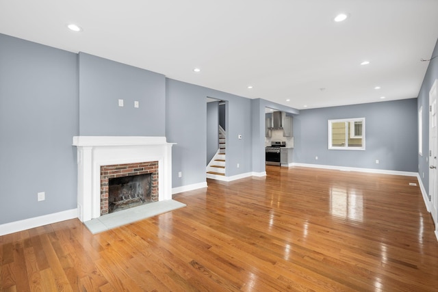 unfurnished living room featuring a fireplace and light wood-type flooring