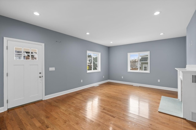 unfurnished living room with light wood-type flooring