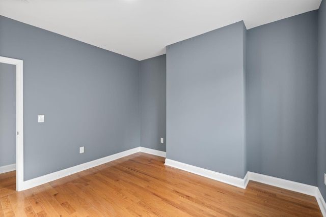 unfurnished room with hardwood / wood-style floors