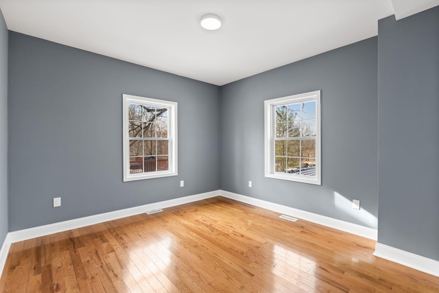 spare room with wood-type flooring