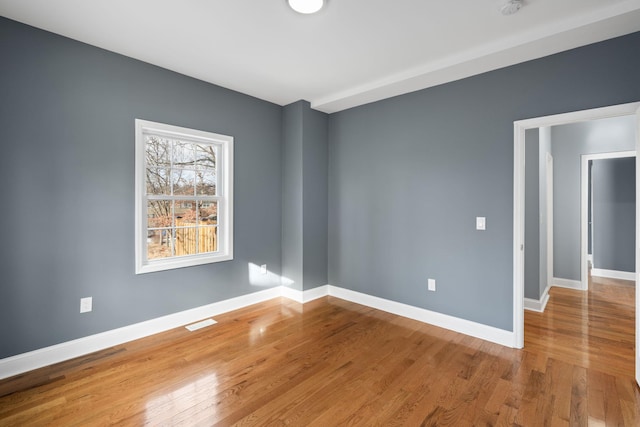 unfurnished room with wood-type flooring