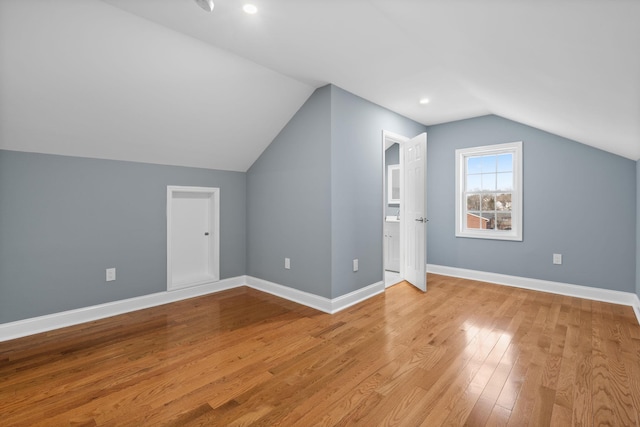 bonus room featuring light wood-type flooring and lofted ceiling